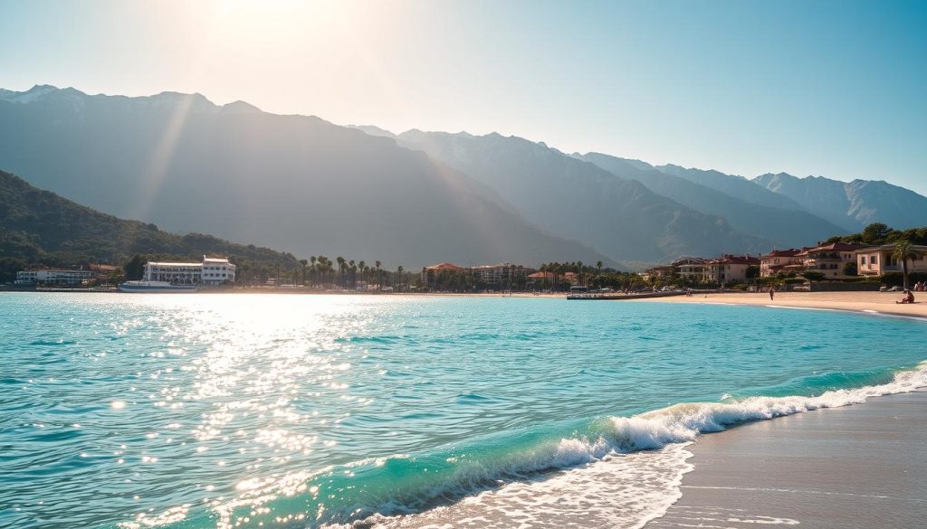 A serene Turkish seaside resort nestled along the azure waters of the Mediterranean. Majestic, snow-capped mountains rise in the distance, framing a picturesque coastline dotted with palm trees and vibrant, whitewashed buildings. Sunlight dances across the gently lapping waves, casting a warm, golden glow over the scene. In the foreground, a pristine, private beach beckons, inviting visitors to relax and unwind. Realistic, high-quality photograph by 7fishing.com.ua.