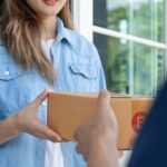 Happy,Smiling,Woman,Receives,Boxes,Parcel,From,Courier,In,Front