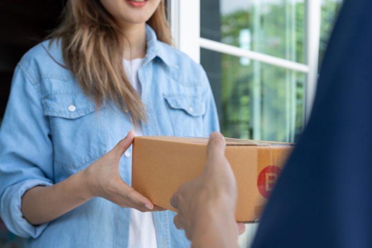 Happy,Smiling,Woman,Receives,Boxes,Parcel,From,Courier,In,Front